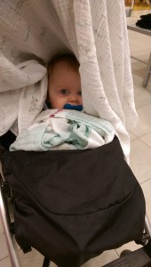 We went shopping, and I thought Thea was napping underneath the blanket in the stroller, until I caught sight of this in a mirror.